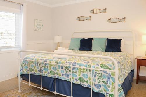 a bedroom with a bed with a metal bed frame at Deja Blue by Pristine Properties Vacation Rentals in Mexico Beach