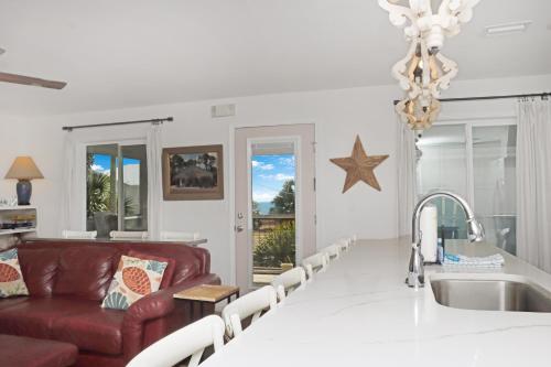 a kitchen and living room with a red couch at Latitude Adjustment by Pristine Properties Vacation Rentals in Indian Pass