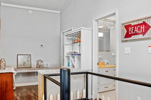 a kitchen with white cabinets and a counter top at Quarters B by Pristine Properties in Mexico Beach