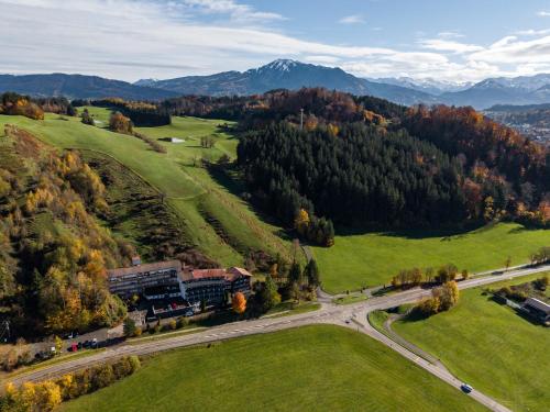 a train is traveling down a road in a field at Rothenfels Panorama Hotel in Immenstadt im Allgäu