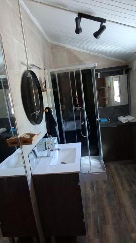 a bathroom with a white sink and a shower at Maison de pêcheur in Marseillan
