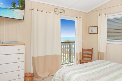 a bedroom with a bed and a view of the ocean at Summer Breeze by Pristine Properties Vacation Rentals in Indian Pass