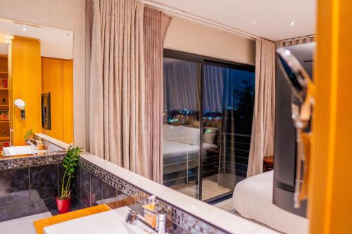 a bathroom with a sink and a mirror at AB&AB Guesthouse Bedfordview in Germiston