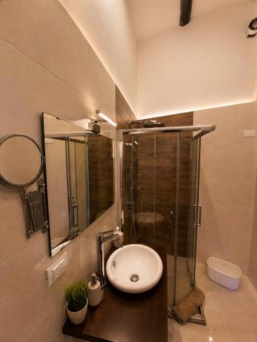 a bathroom with a sink and a glass shower at RELAIS TORRE GLORIA in Naples