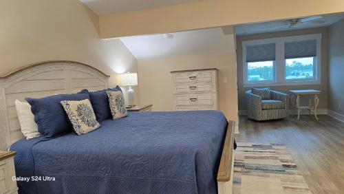a bedroom with a blue bed and a dresser at Las Brisas By Pristine Property Vacation Rentals in Saint Joe Beach