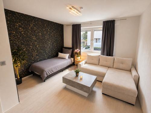 a living room with a couch and a bed at Harpener Hellweg 457 in Bochum