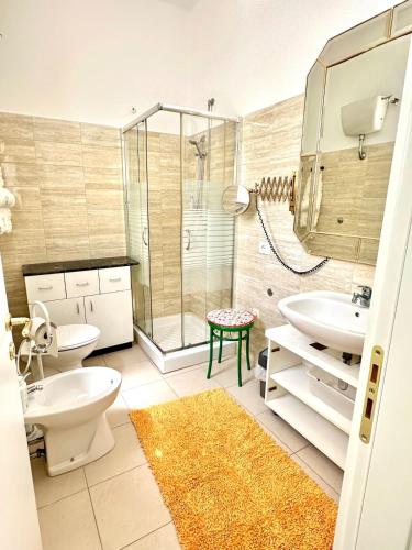 a bathroom with a shower and a toilet and a sink at Casa della Nonna - Art & Vintage Rooms in Noicattaro