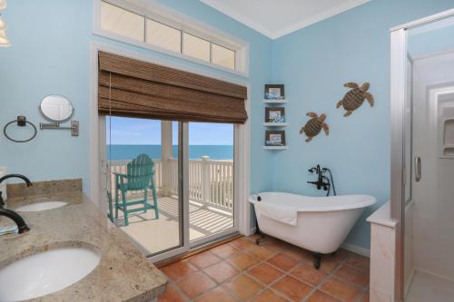 a bathroom with two sinks and a tub and a balcony at Coastal Cove by Pristine Properties Vacation Rentals in Indian Pass