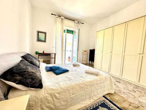a bedroom with a large bed with blue pillows on it at Casa della Nonna - Art & Vintage Rooms in Noicattaro