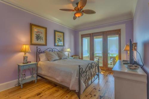 a bedroom with a bed and a ceiling fan at Island Idyl by Pristine Properties Vacation Rentals in Indian Pass