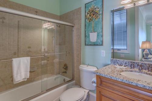 a bathroom with a toilet and a shower and a sink at Island Idyl by Pristine Properties Vacation Rentals in Indian Pass