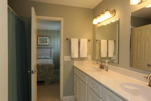 a bathroom with two sinks and a mirror at One More Time Again by Pristine Properties Vacation Rentals in Mexico Beach