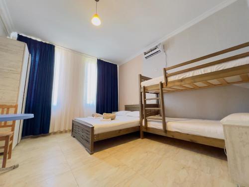 a bedroom with two bunk beds and a window at Gulis Home in Shekhvetili