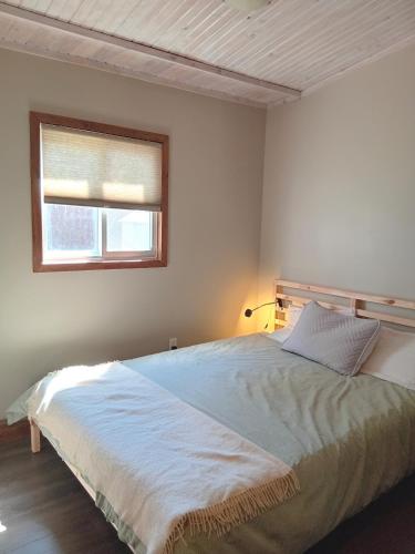 a bedroom with a large bed with a window at Guest Suite in Smiths Falls