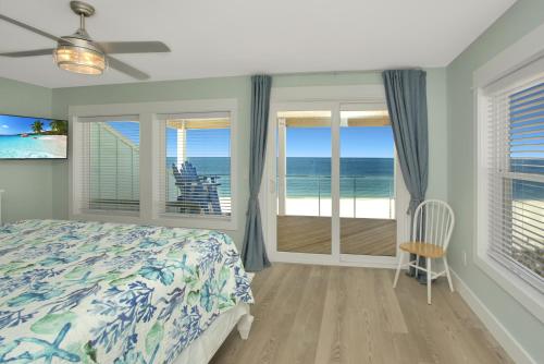 a bedroom with a bed and a view of the ocean at Shore Looks Good by Pristine Properties Vacation Rentals in Mexico Beach