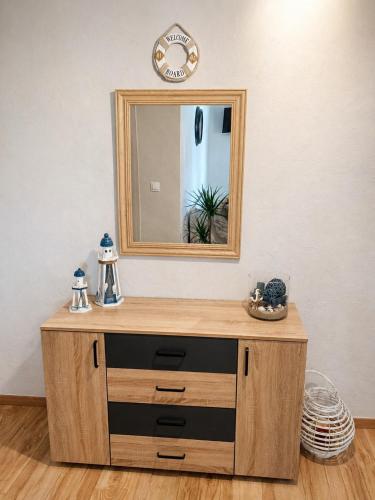 a wooden dresser with a mirror on a wall at Stella's House Mangana in Mángana