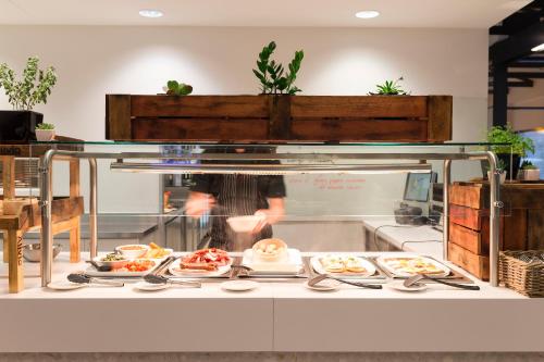 a buffet line with plates of food on display at Alivio Tourist Park Canberra in Canberra