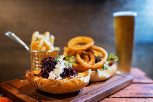 a table topped with pretzels and a basket of onion rings at Alivio Tourist Park Canberra in Canberra