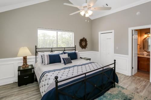 a bedroom with a bed and a ceiling fan at A Swell Life by Pristine Properties Vacation Rentals in Cape San Blas