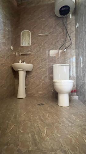 a bathroom with a toilet and a sink at Gulis Home in Shekhvetili