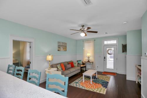 a living room with a couch and a table at Barefoot Cottage D133 - Beachy Keen by Pristine Properties Vacation Rentals in Highland View