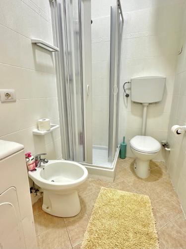 a bathroom with a shower and a toilet and a sink at A DUE PASSI da BARI - La Casa della Nonna al 39 in Noicattaro