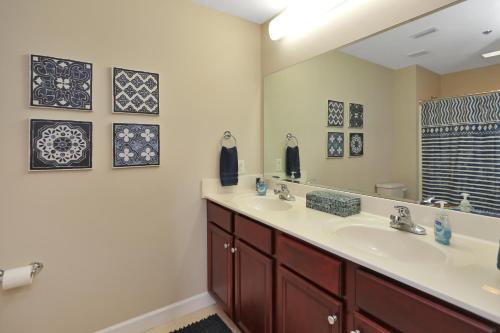 a bathroom with two sinks and a mirror at Waterside Village Condo 203 by Pristine Properties Vacation Rentals in Mexico Beach