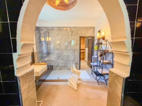 an arched hallway with a staircase in a home at Villa Mano in Marrakesh