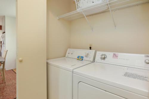 a white washer and dryer in a small room at Boardwalk Sandpiper by Pristine Properties Vacation Rentals in Cape San Blas
