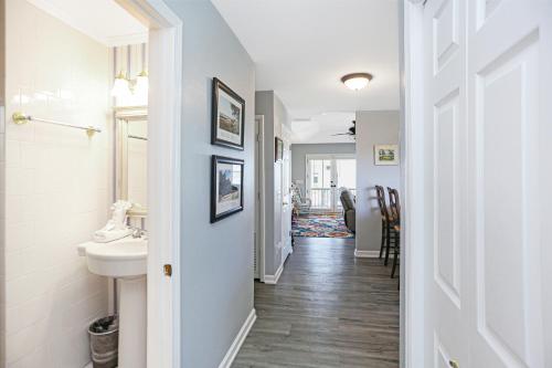a hallway of a bathroom with a sink and a toilet at Flamingo Roost by Pristine Properties Vacation Rentals in Indian Pass