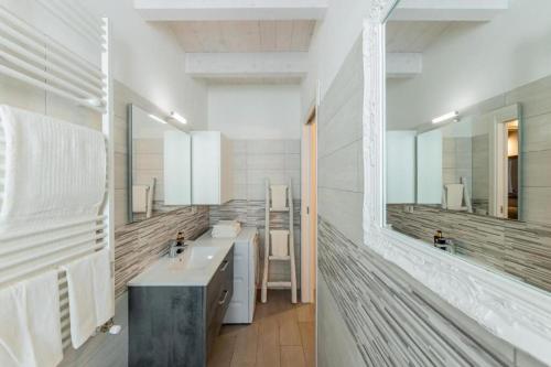 a bathroom with two sinks and a large mirror at Aura Milanese Milano in Milan