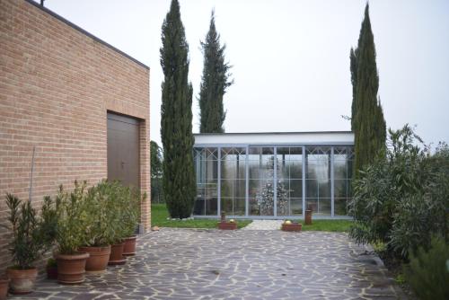 a brick building with trees in front of it at Dolce Casetta in Faenza