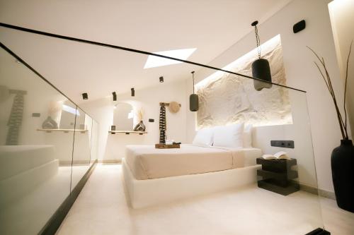a bathroom with a white tub and a sink at ŌMNIMI Signature Living in Skala Potamias