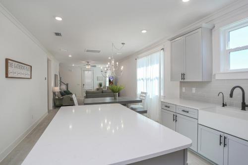 a kitchen with white cabinets and a white counter top at Keys to the Cape by Pristine Properties Vacation Rentals in Cape San Blas