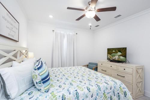 a bedroom with a bed and a ceiling fan at Keys to the Cape by Pristine Properties Vacation Rentals in Cape San Blas