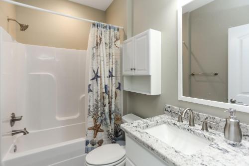 a bathroom with a sink and a toilet and a shower at Lala's Place by Pristine Properties Vacation Rentals in Mexico Beach