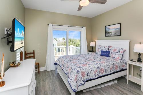 a bedroom with a bed and a window at Lala's Place by Pristine Properties Vacation Rentals in Mexico Beach