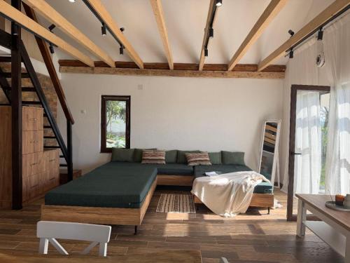 a room with a bed and a couch in it at Hotel Cider&Squash garden haus, Grncarska 6, Prnjavor in Prnjavor