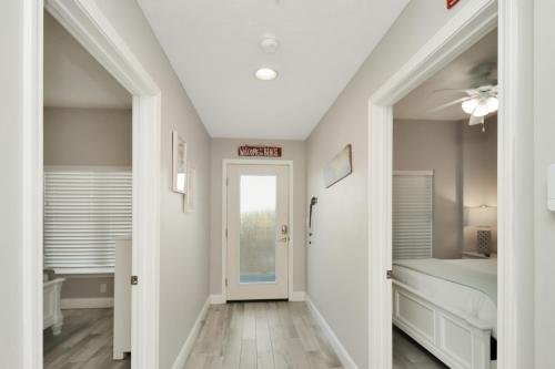 a hallway with a door leading to a bedroom at Summerhouse 106 by Pristine Properties Vacation Rentals in Mexico Beach