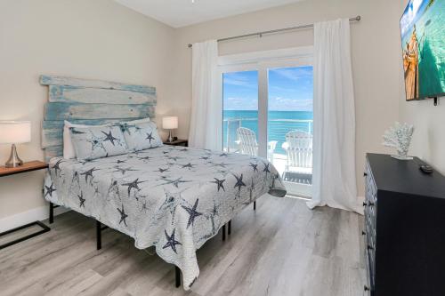 a bedroom with a bed and a view of the ocean at Beach Fantasies B by Pristine Properties Vacation Rentals in Mexico Beach