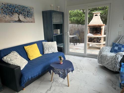 a living room with a blue couch and a fireplace at Villa Casa rosa Maria in Platja d'Aro