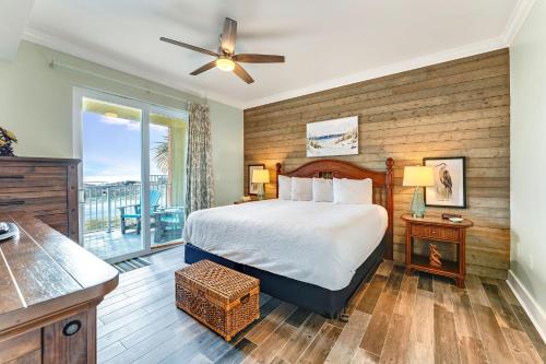 a bedroom with a bed and a balcony at Summerhouse 101 - Pearl of the Gulf by Pristine Properties Vacation Rentals in Mexico Beach