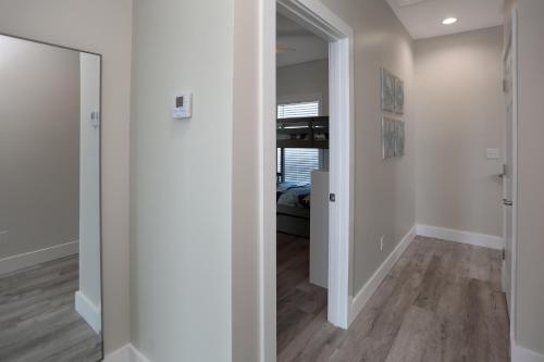 a hallway with white walls and wood floors and a door at Beach Fantasies A by Pristine Properties Vacation Rentals in Mexico Beach
