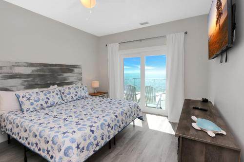 a bedroom with a bed and a window with a view at Beach Fantasies A by Pristine Properties Vacation Rentals in Mexico Beach