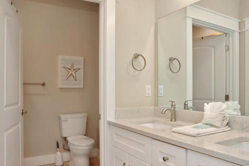 a bathroom with a sink and a toilet and a mirror at The Great White 2 by Pristine Properties Vacation Rentals in Beacon Hill