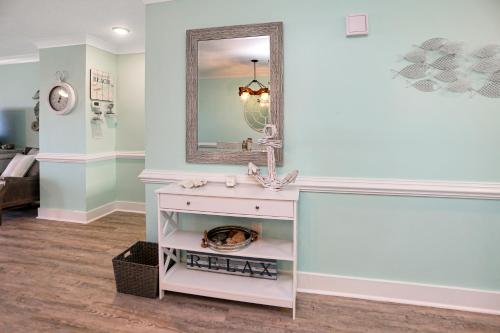 a bathroom with a sink and a mirror at Edgewater Retreat by Pristine Properties Vacation Rentals in Cape San Blas