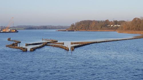 a dock in the middle of a large body of water at Lieblingsplatz in Kappeln