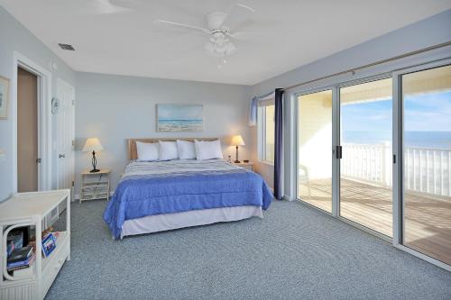 a bedroom with a bed and a balcony at Pelican Landing 3 by Pristine Properties Vacation Rentals in Indian Pass