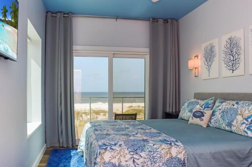 a bedroom with a bed and a view of the ocean at Sea La Vie by Pristine Properties Vacation Rentals in Mexico Beach