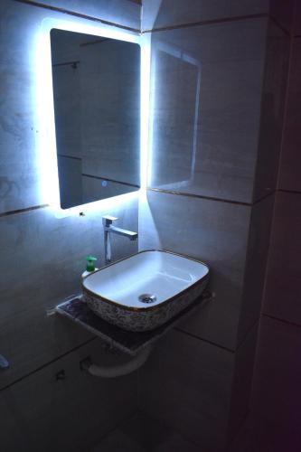 a bathroom with a sink and a mirror at Mehi villa in Ghaziabad